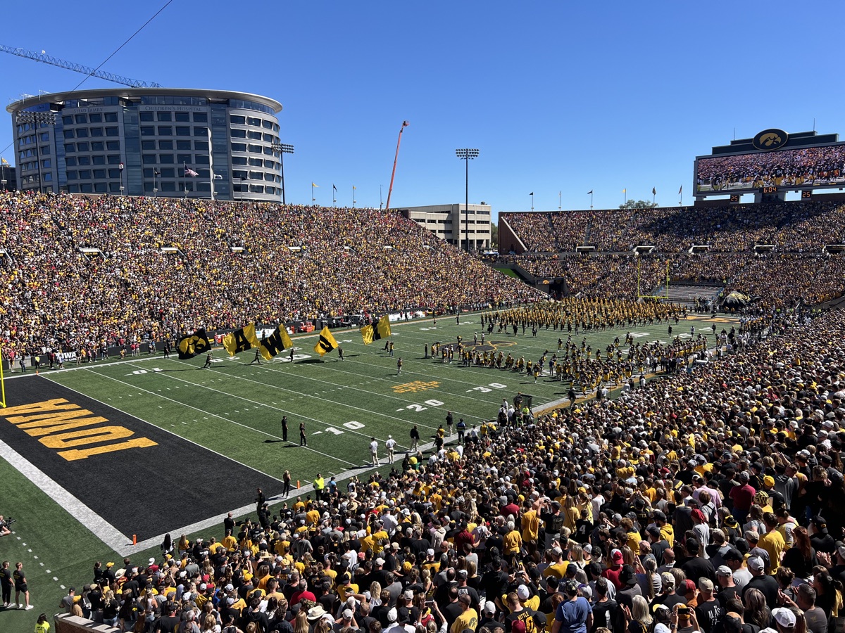 Kinnick Stadium game-day view with Iowa flags on the field
